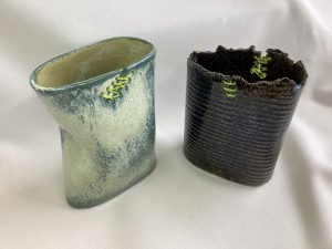 Vases with fishing line sewn into cracks
