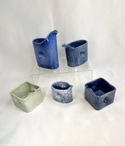 Blue and green jugs. Indents on each side for easy gripping