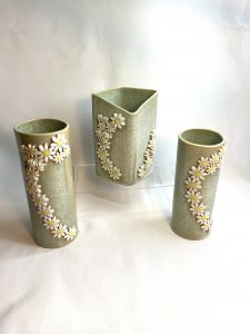 3 Green vases with a pattern of daisy sprigs