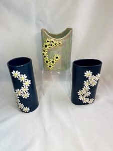 Blue and green vases with flower sprigs