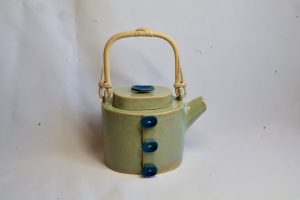 Oval slab built teapot. Green with a bamboo handle