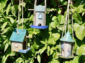 Three bird feeders based on castles and buildings.